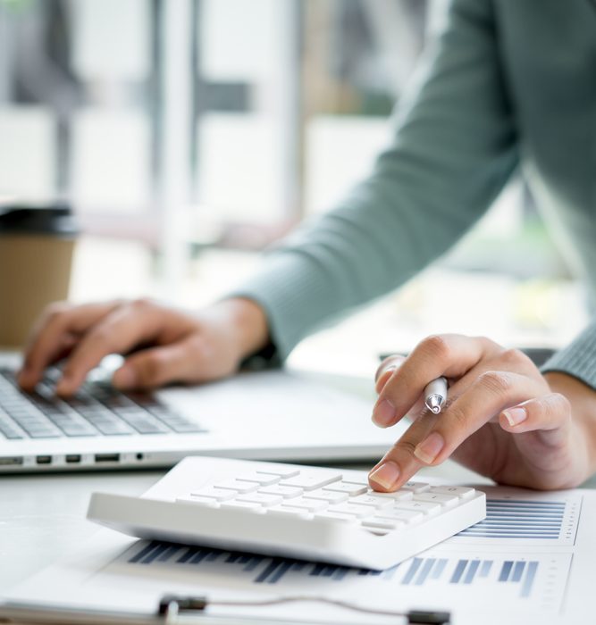 accountant hand working on calculator